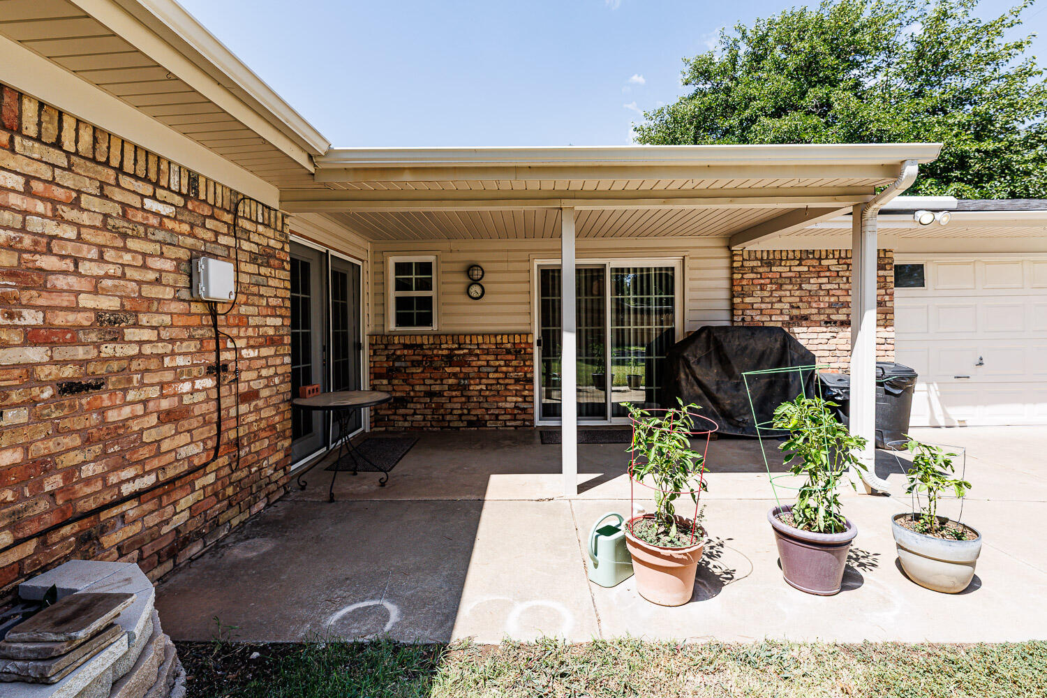 3816 53rd Street Lubbock, TX 79413 - Photo 54 of 59 a view of a patio with couches table and chairs and potted plants