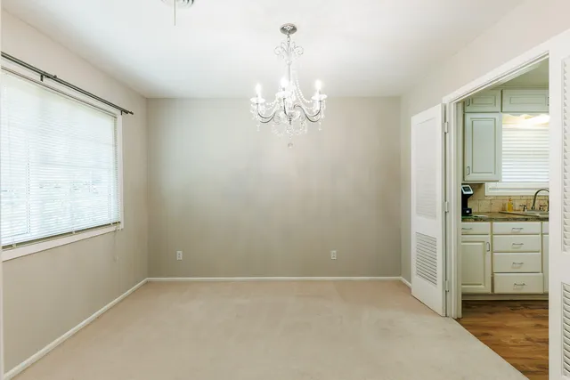 a kitchen with a sink a stove cabinets and wooden floor