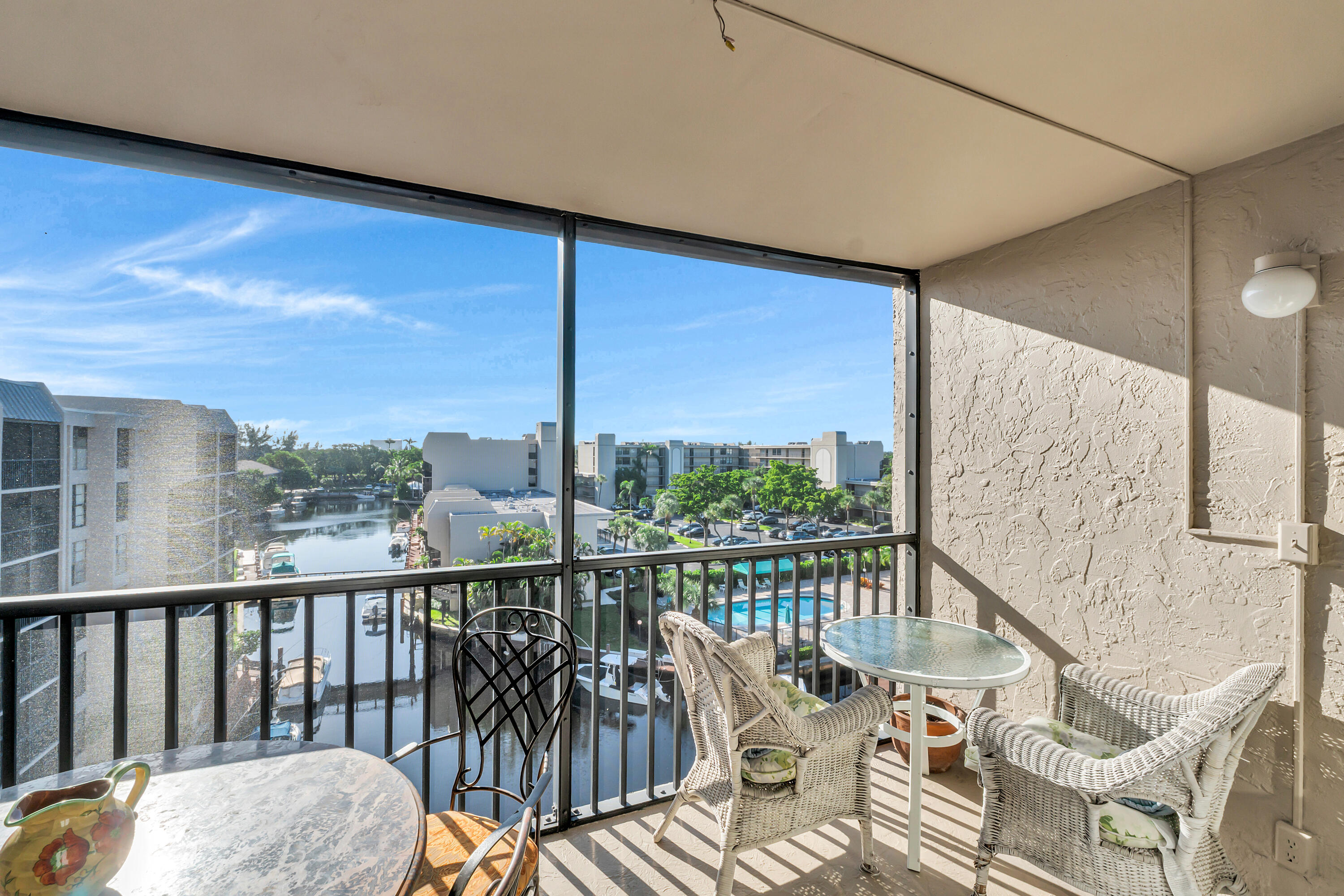 4 Royal Palm Way, Unit 601 Boca Raton, FL 33432 - Photo 1 of 34 a balcony with wooden floor table and chairs
