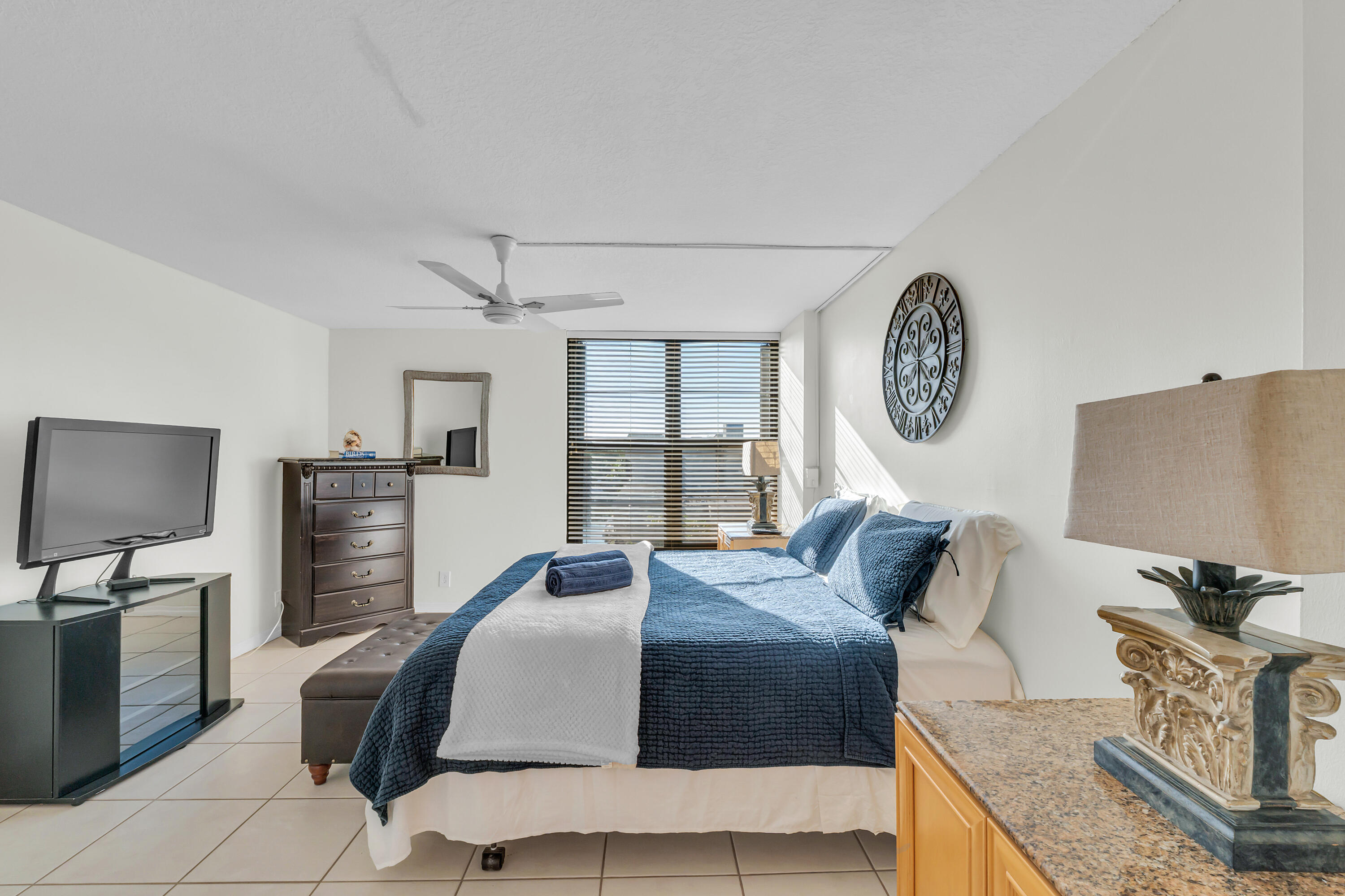 4 Royal Palm Way, Unit 601 Boca Raton, FL 33432 - Photo 18 of 34 a bedroom with a bed a couch and dresser