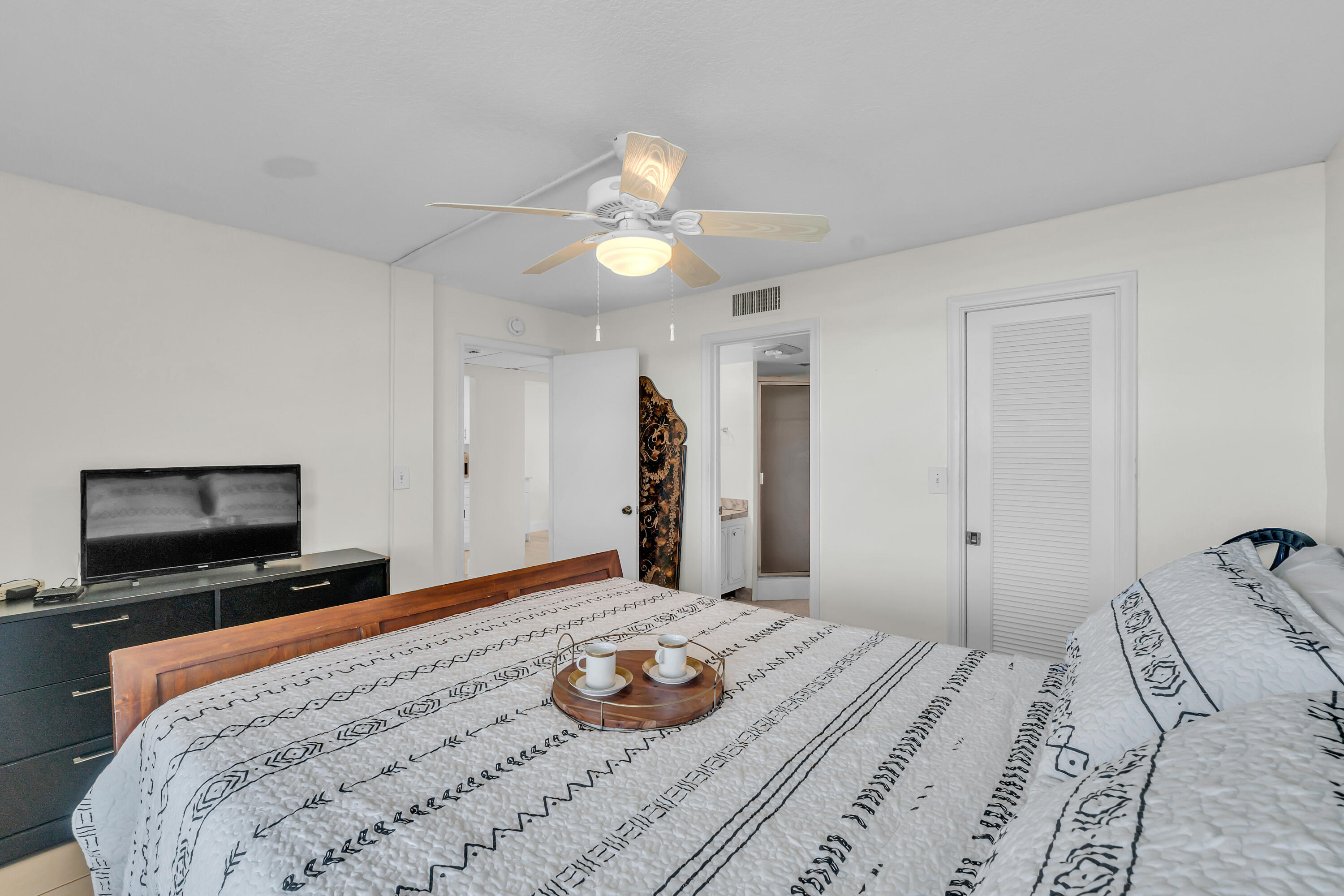 4 Royal Palm Way, Unit 601 Boca Raton, FL 33432 - Photo 26 of 34 a bedroom with a bed and a flat screen tv