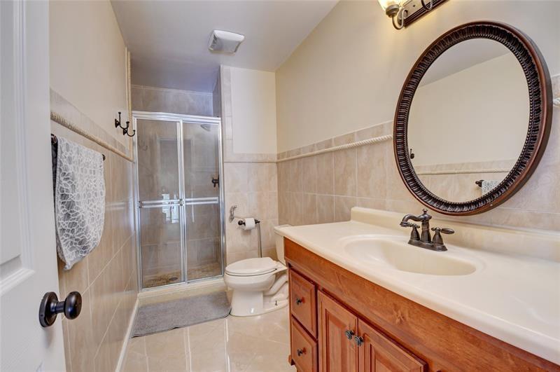 9316 Ketay Circle Boca Raton, FL 33428 - Photo 22 of 30 a bathroom with a sink a mirror a toilet and a shower