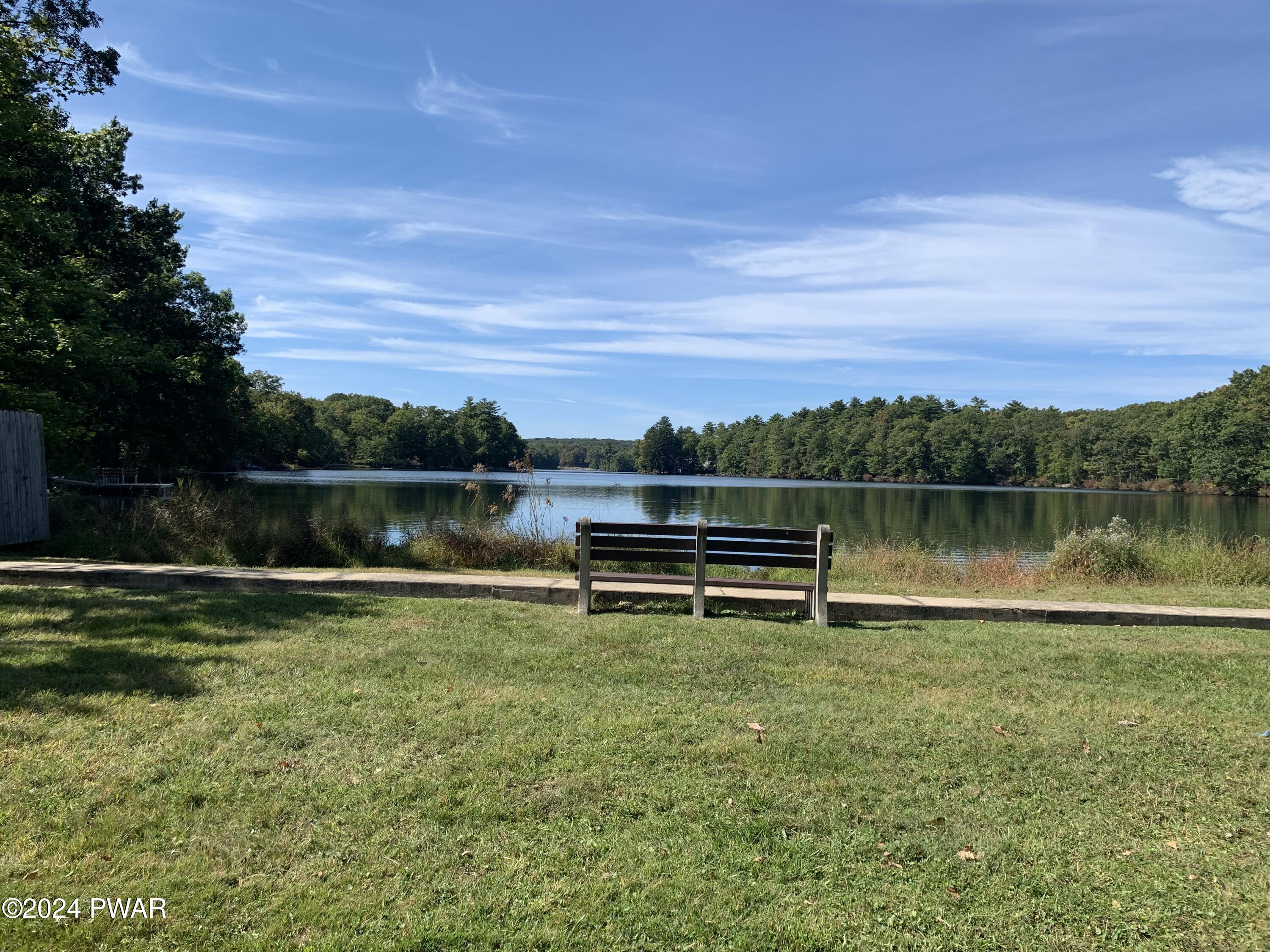 136 Stamford Road Dingmans Ferry, PA 18328 - Photo 51 of 52 a view of a lake with houses in the back
