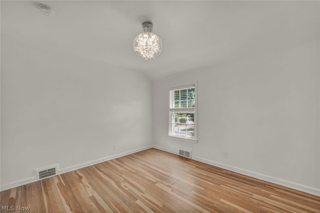 3543 Lytle Road Shaker Heights, OH 44122 - Photo 31 of 49 Bright room with wood-finish flooring, white walls, and a modern chandelier