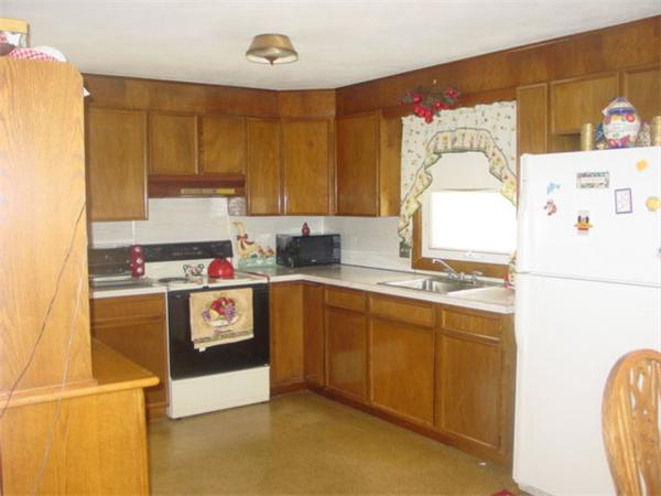 185 Roy Street Springfield, MA 01104 - Photo 7 of 8 a kitchen with cabinets a sink and white appliances