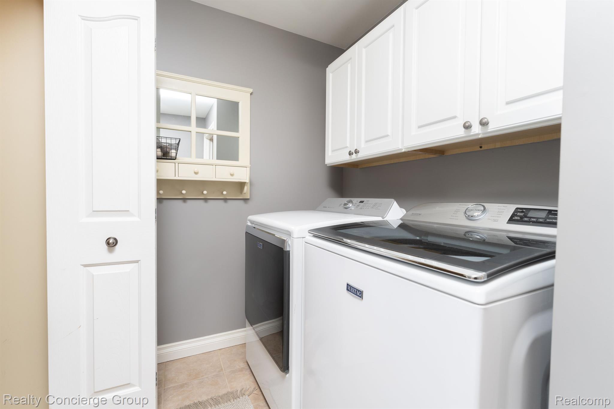 1172 Thorn Ridge Drive Howell, MI 48843 - Photo 18 of 71 Convenient 1st floor laundry w/ cabinet storage