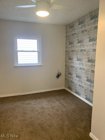 284 Altamont Road Vermilion, OH 44089 - Photo 26 of 39 Spare room with an accent wall, dark colored carpet, and baseboards