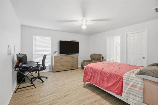 a bedroom with a bed and a flat screen tv