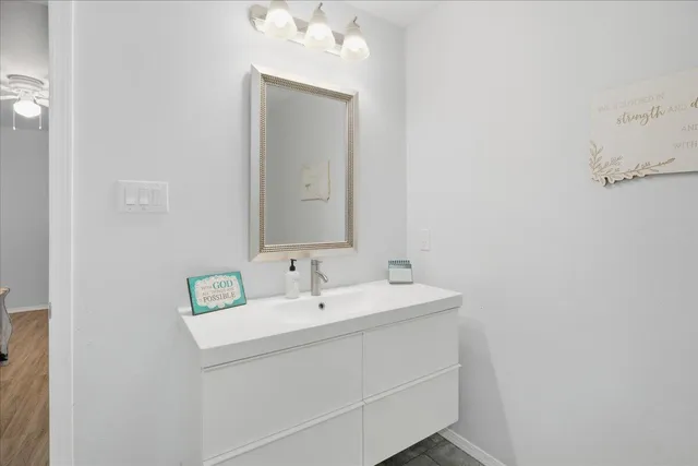 a bathroom with a sink vanity and mirror