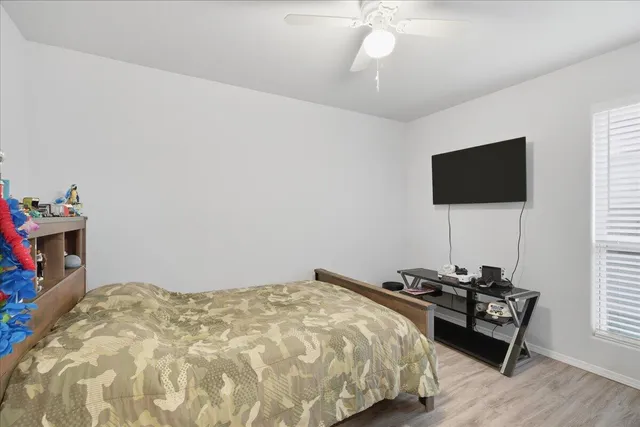 a bedroom with a bed and a flat screen tv