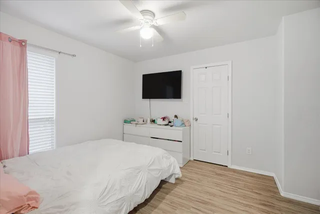 a bedroom with a bed and a flat screen tv