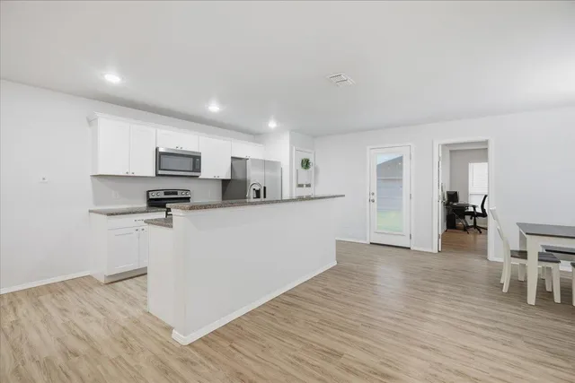 a kitchen with stainless steel appliances a refrigerator sink and microwave
