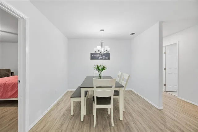 a dining room with furniture and wooden floor
