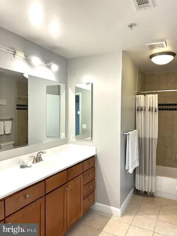 a bathroom with a double vanity sink and a mirror