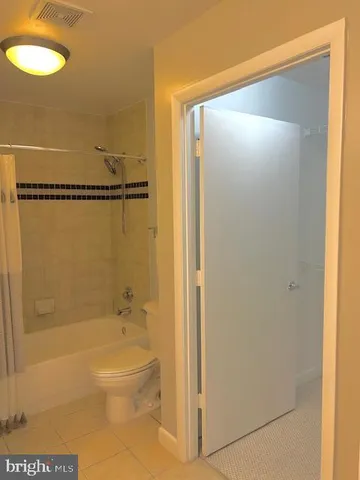 a bathroom with a shower and a toilet