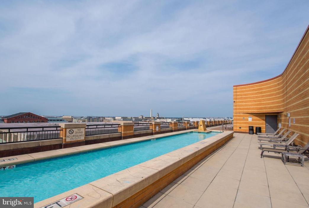 400 Massachusetts Avenue Northwest, Unit 608 Washington, DC 20001 - Photo 18 of 25 a view of swimming pool with chairs in back yard