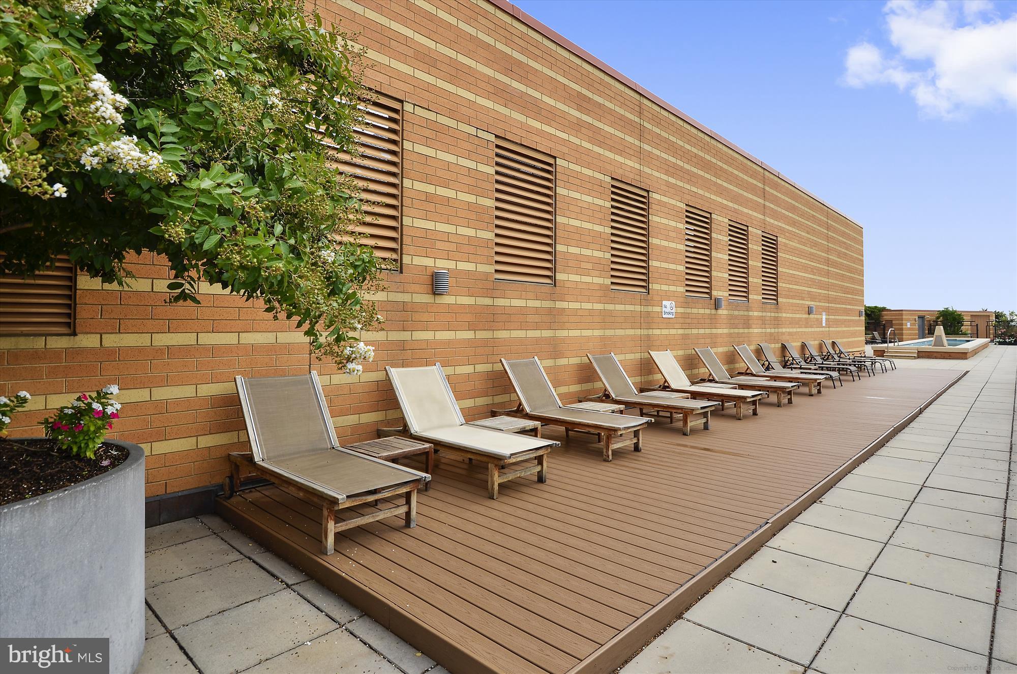 400 Massachusetts Avenue Northwest, Unit 608 Washington, DC 20001 - Photo 19 of 25 a roof deck with outdoor seating and trees