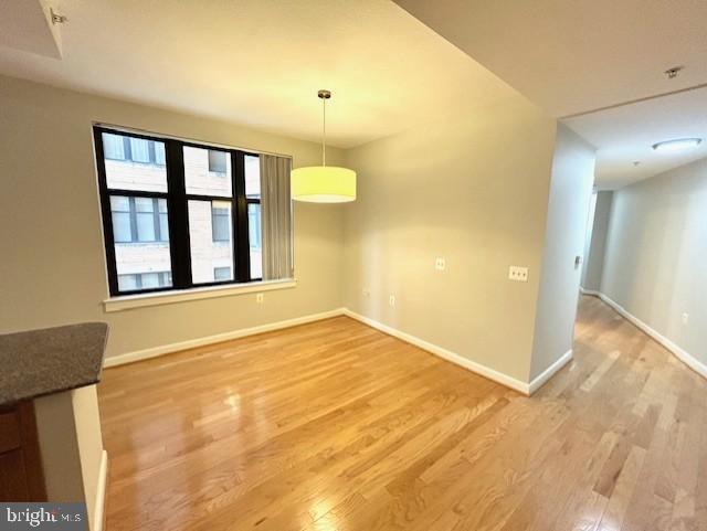 400 Massachusetts Avenue Northwest, Unit 608 Washington, DC 20001 - Photo 4 of 25 a view of an empty room with wooden floor and a window