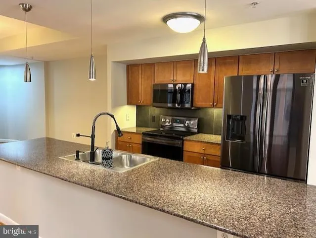 a kitchen with a refrigerator and a sink