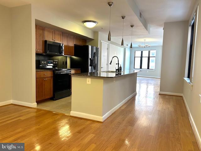 400 Massachusetts Avenue Northwest, Unit 608 Washington, DC 20001 - Photo 25 of 25 a kitchen with stainless steel appliances granite countertop a refrigerator a sink a stove top oven a counter space and cabinets