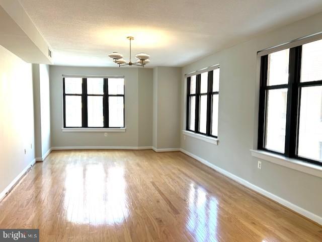 400 Massachusetts Avenue Northwest, Unit 608 Washington, DC 20001 - Photo 8 of 25 a view of an empty room with a window and wooden floor