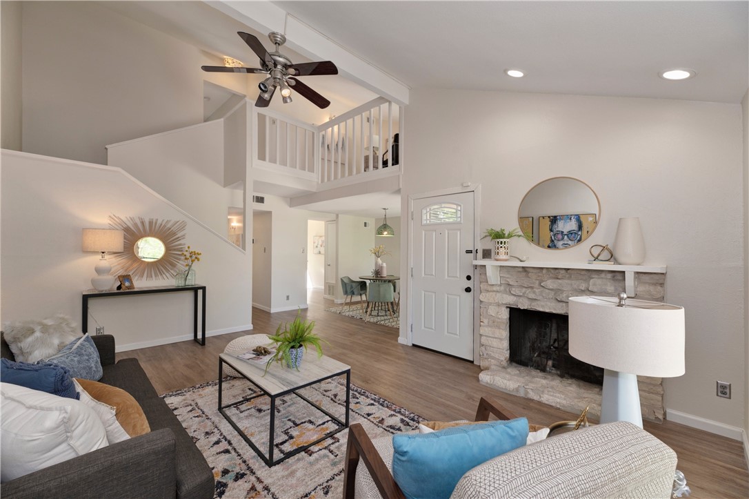 1712 Timber Ridge Drive Austin, TX 78741 - Photo 1 of 1 This home boasts a spacious family room with wood floors, custom fan, and the architectural interest of high ceilings. You can also see how the light comes in naturally.