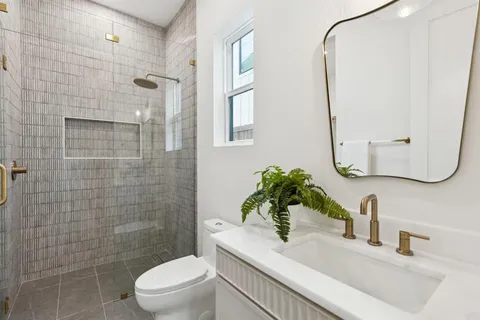 a bathroom with a sink toilet and shower