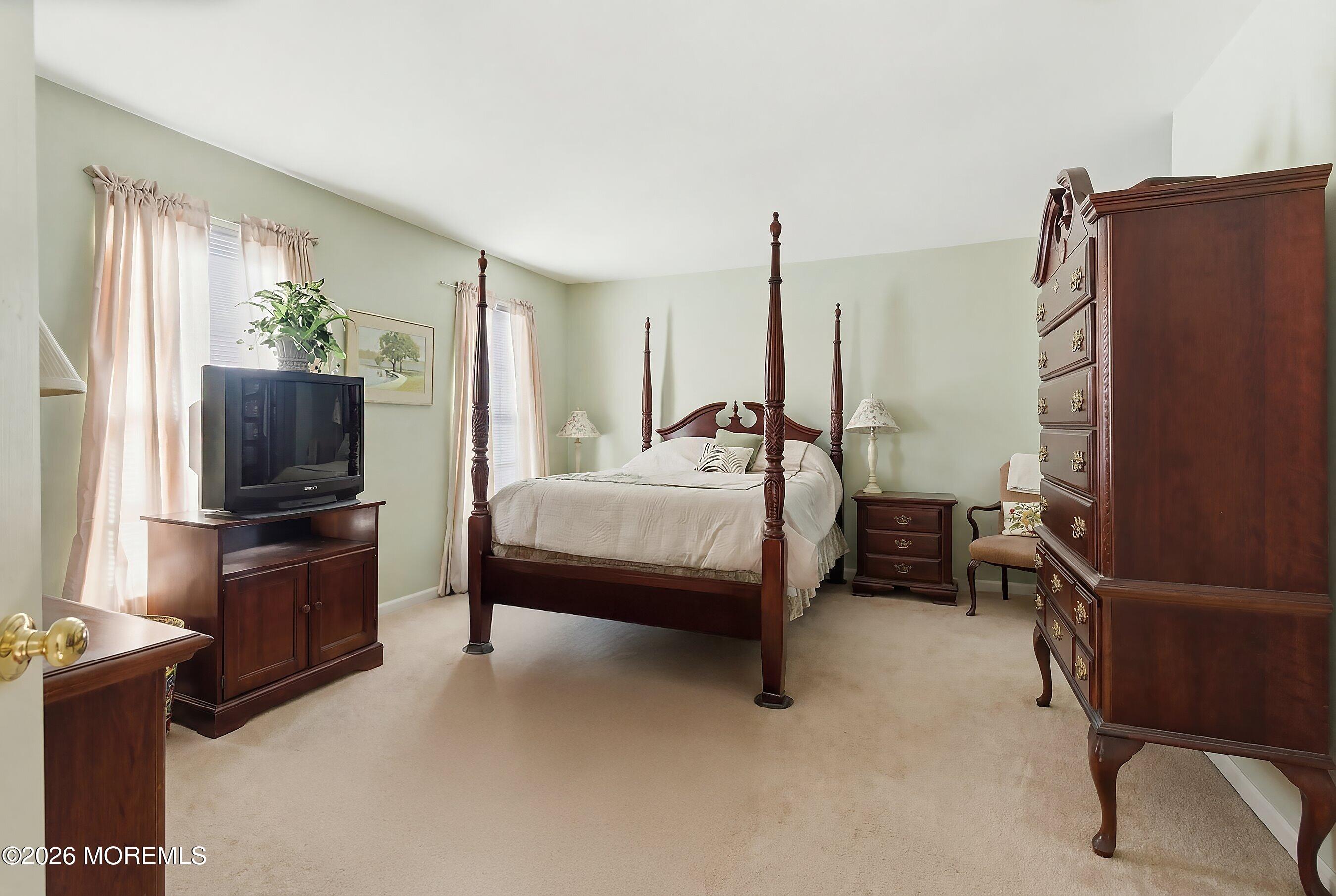 15 Benjamin Court Barnegat, NJ 08005 - Photo 13 of 24 a bedroom with a bed flat screen tv and a large window