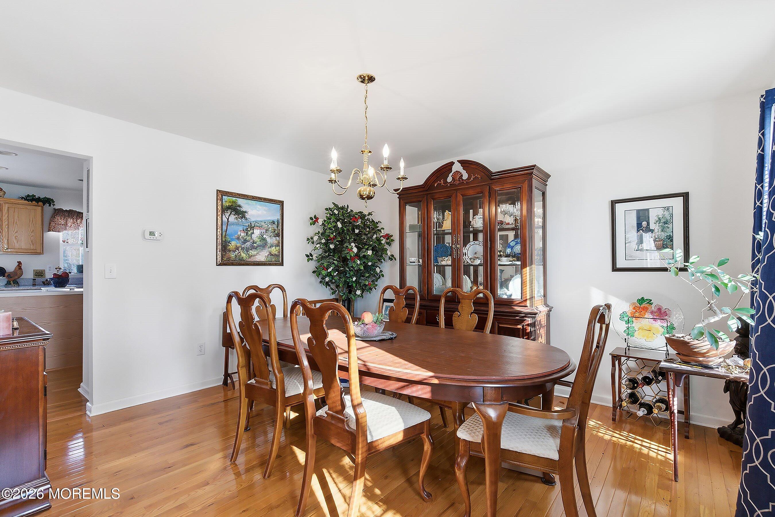 15 Benjamin Court Barnegat, NJ 08005 - Photo 3 of 24 a view of a dining room with furniture and wooden floor