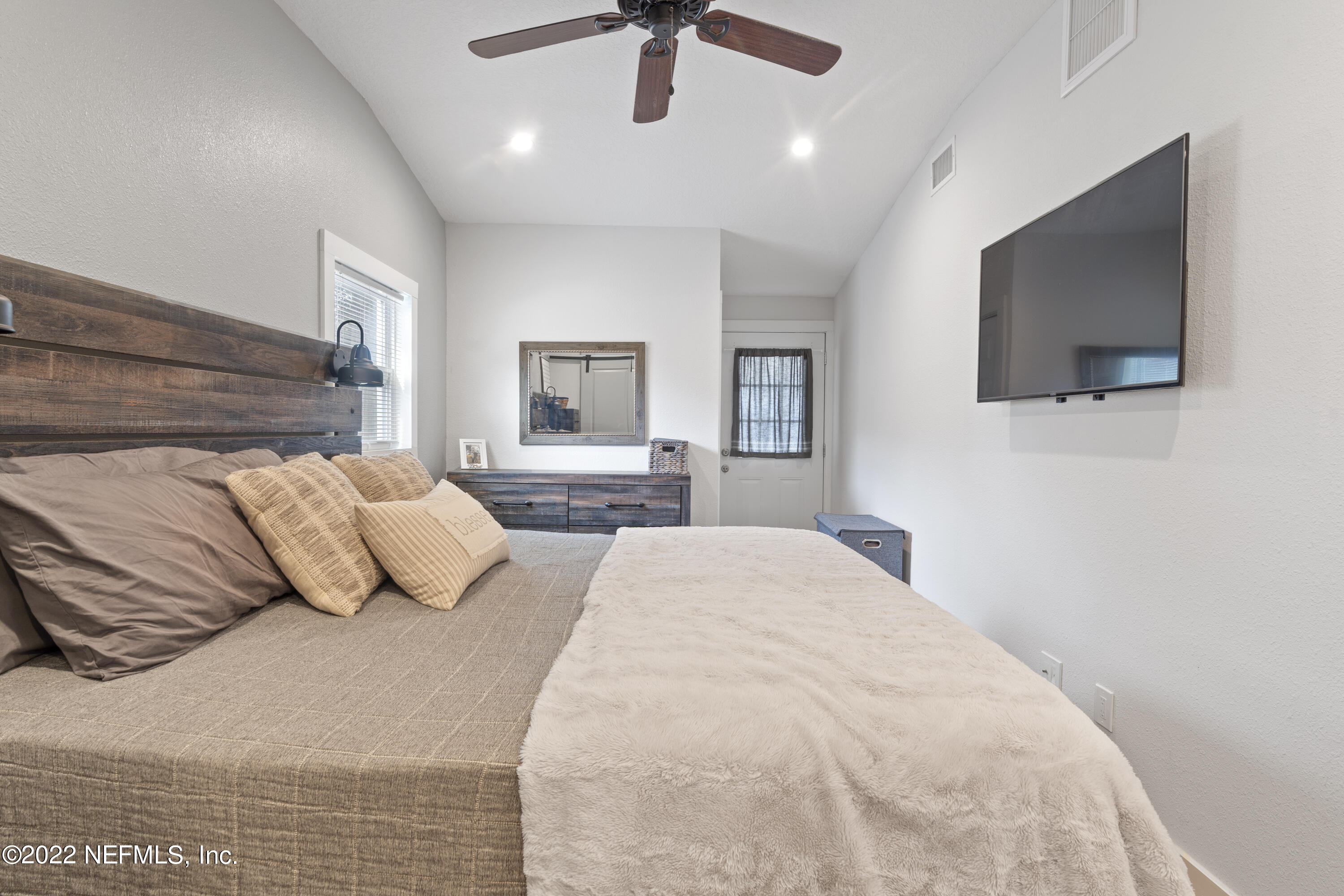 1032 Prince Road St. Augustine, FL 32086 - Photo 29 of 39 a bedroom with a large bed and a flat screen tv