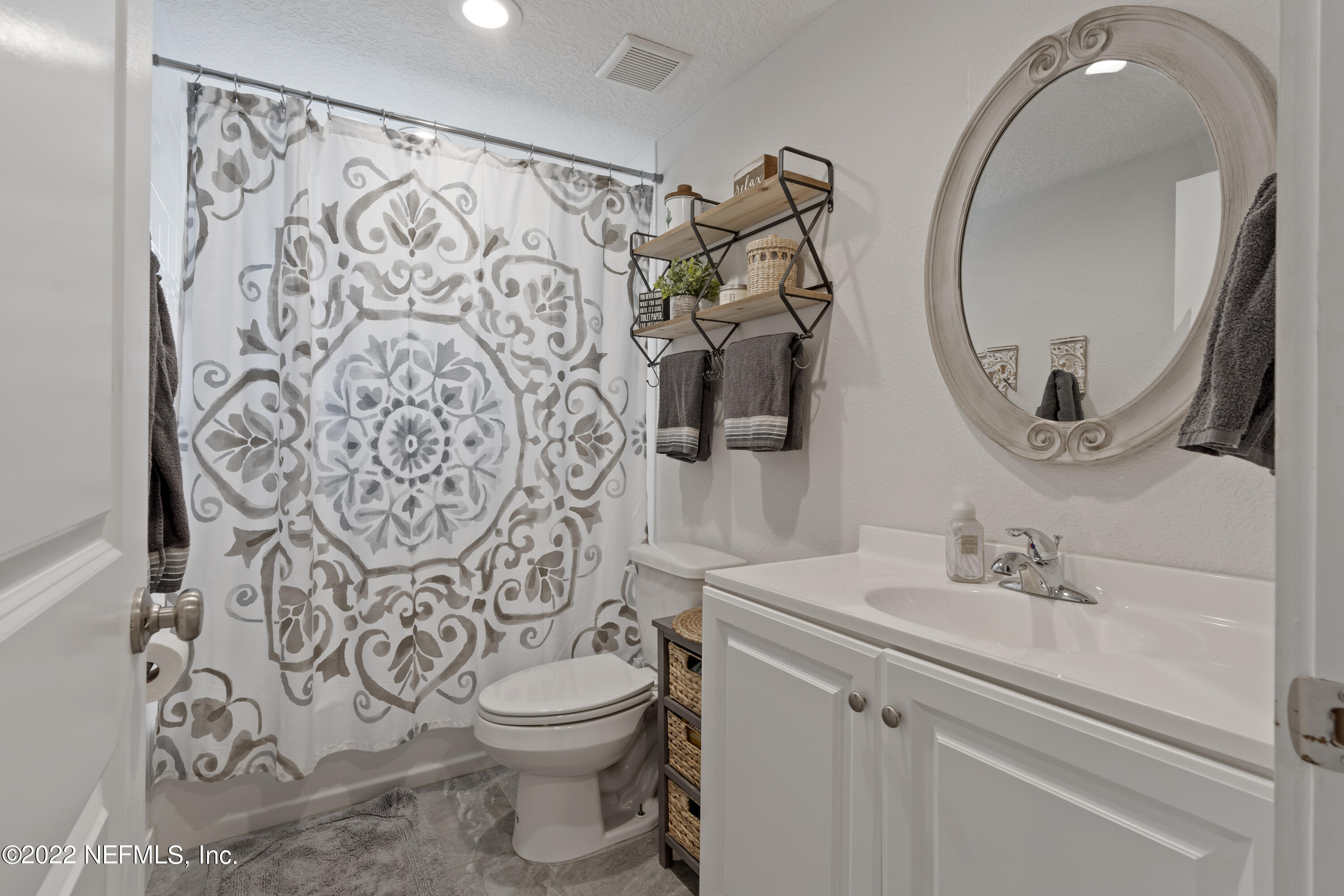1032 Prince Road St. Augustine, FL 32086 - Photo 34 of 39 a bathroom with a toilet sink and mirror