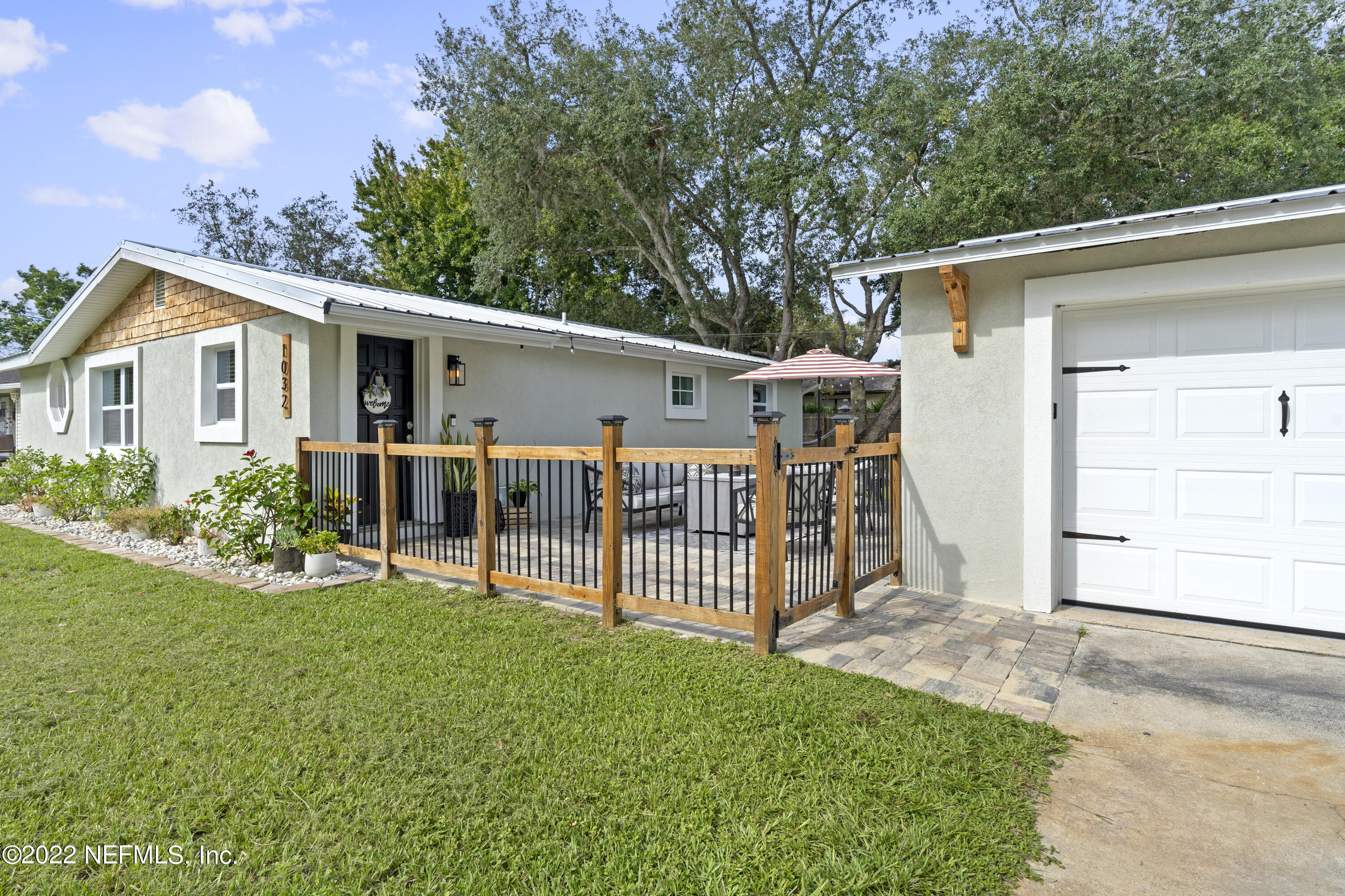 1032 Prince Road St. Augustine, FL 32086 - Photo 4 of 39 a view of a house with a yard and lawn chairs with wooden fence