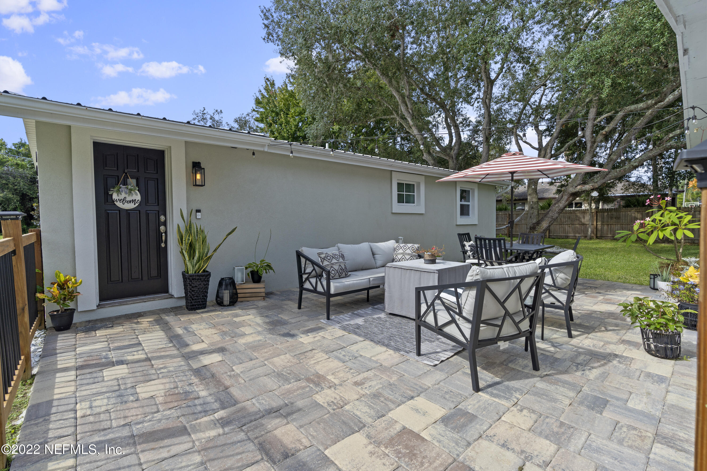 1032 Prince Road St. Augustine, FL 32086 - Photo 6 of 39 a view of a patio with a table and chairs under an umbrella