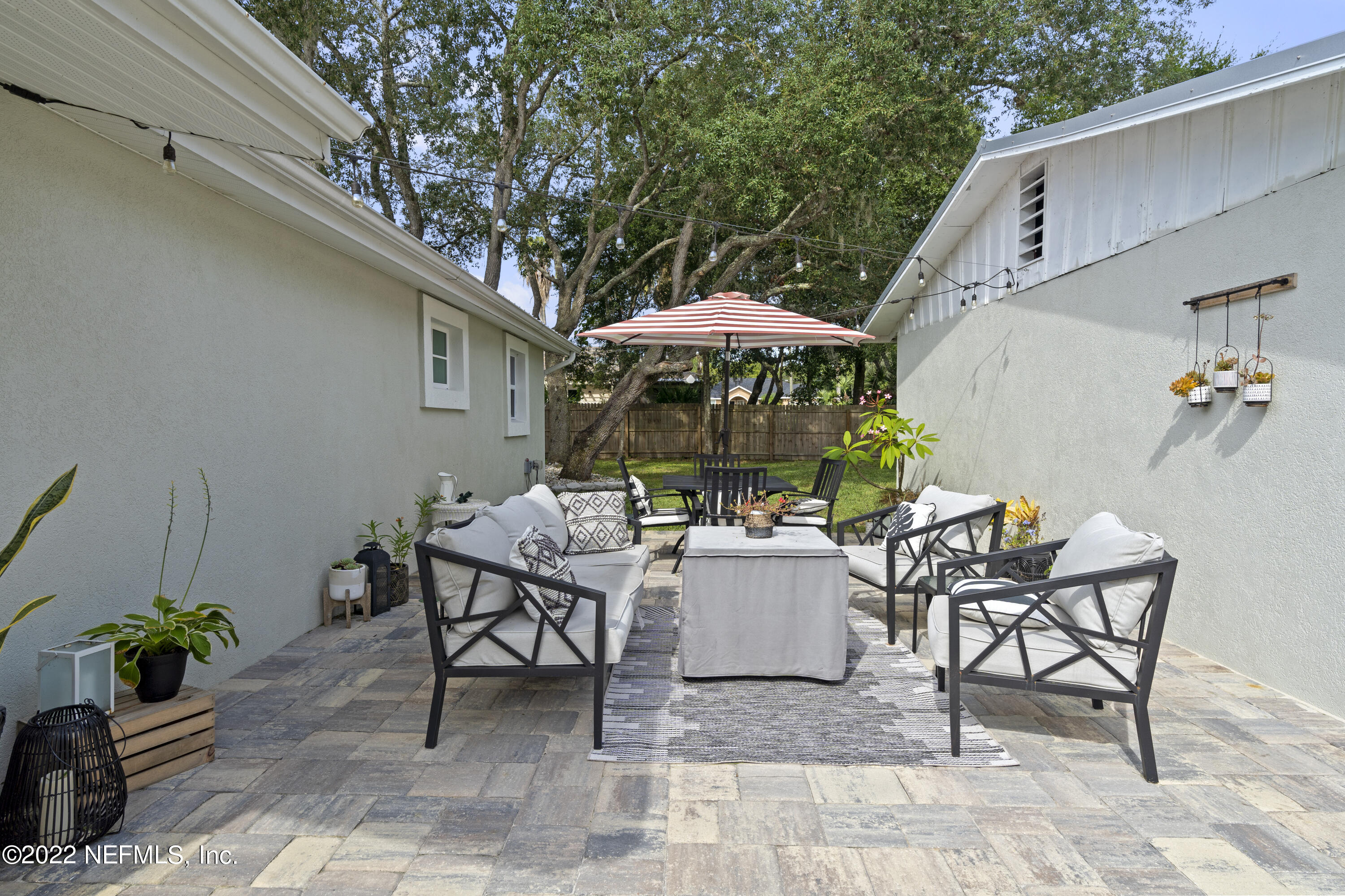 1032 Prince Road St. Augustine, FL 32086 - Photo 7 of 39 a view of a patio with a table and chairs under an umbrella