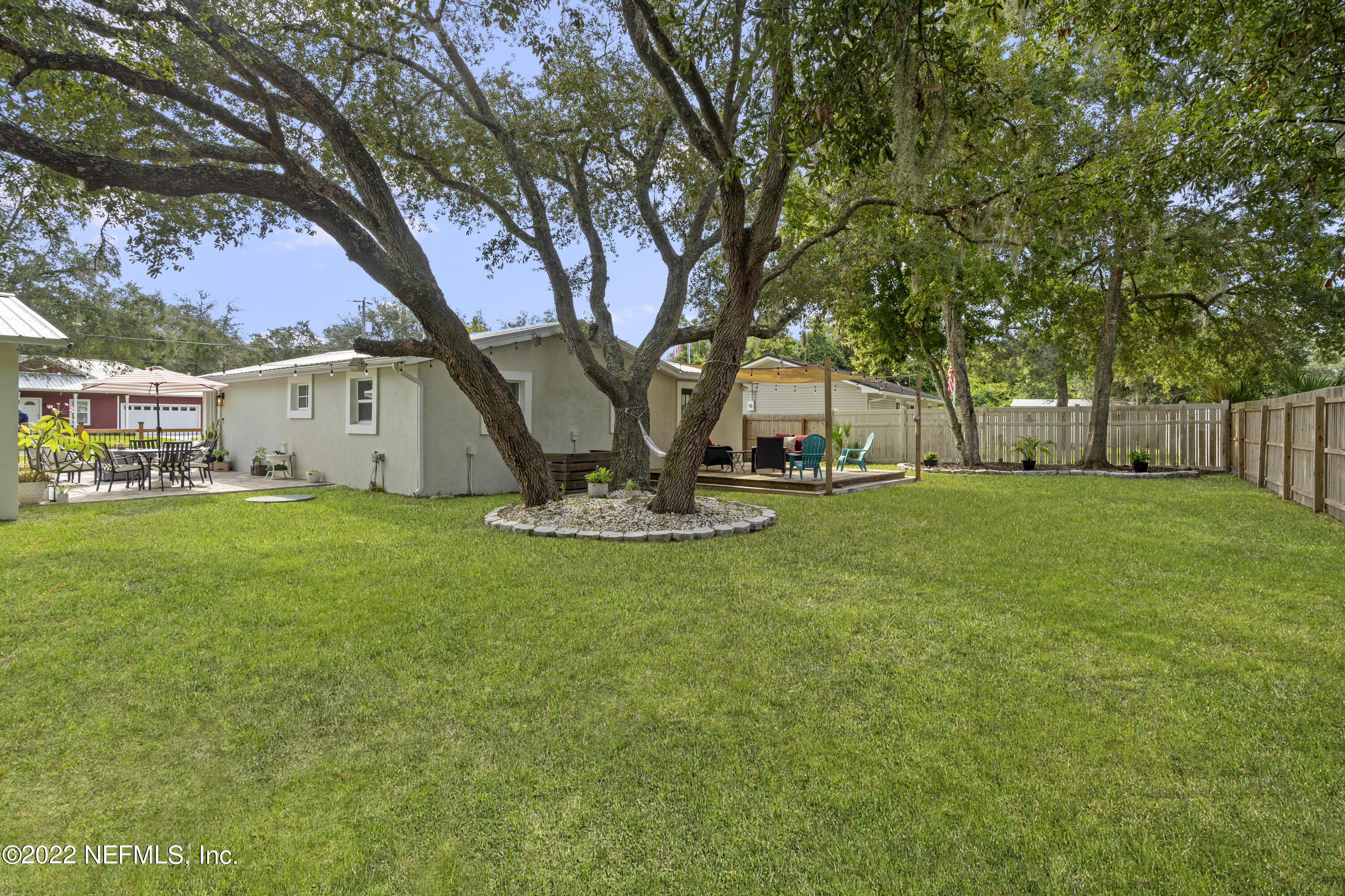1032 Prince Road St. Augustine, FL 32086 - Photo 8 of 39 a view of a white house with a big yard and large tree