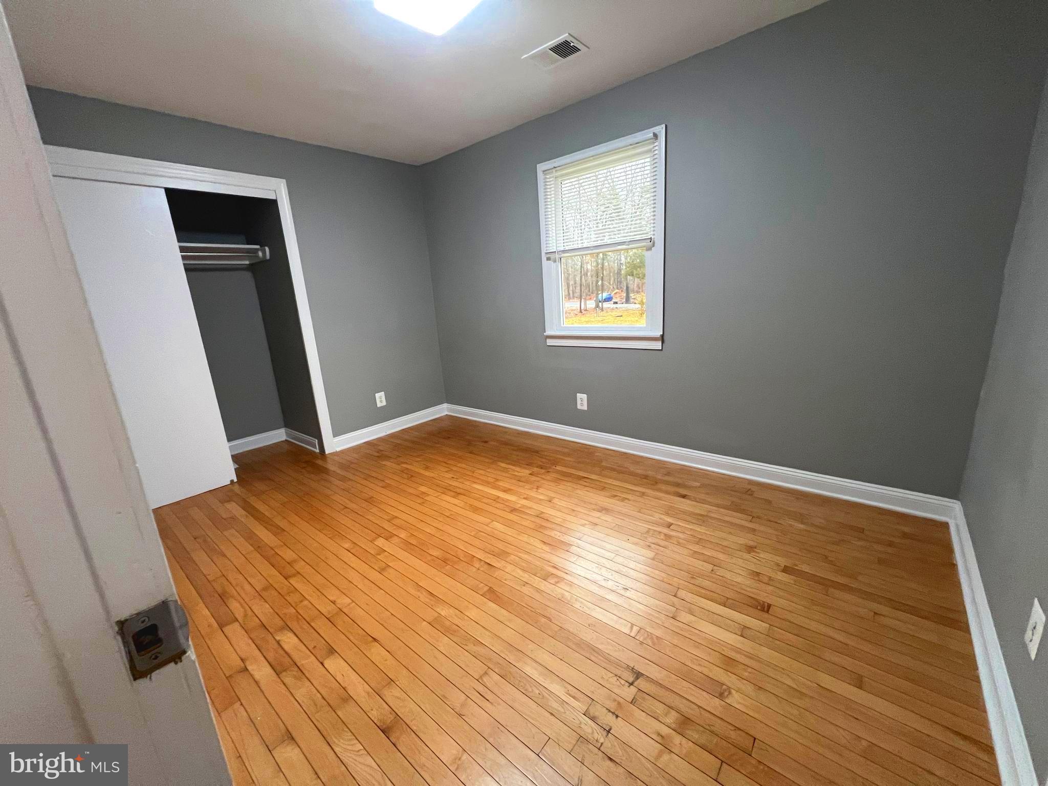 19956 Broad Run Drive Sterling, VA 20165 - Photo 17 of 24 an empty room with wooden floor and windows
