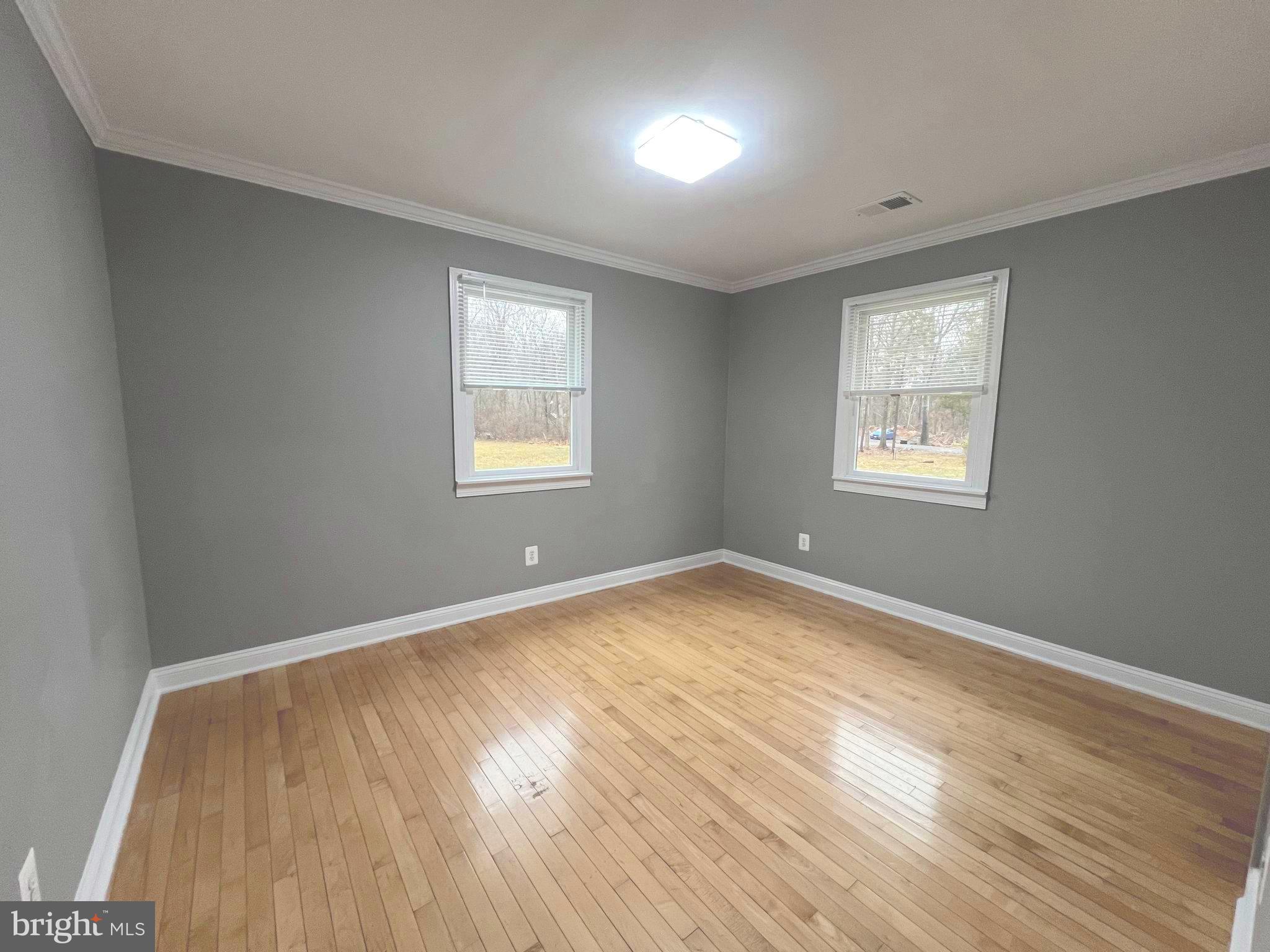 19956 Broad Run Drive Sterling, VA 20165 - Photo 18 of 24 an empty room with wooden floor and windows