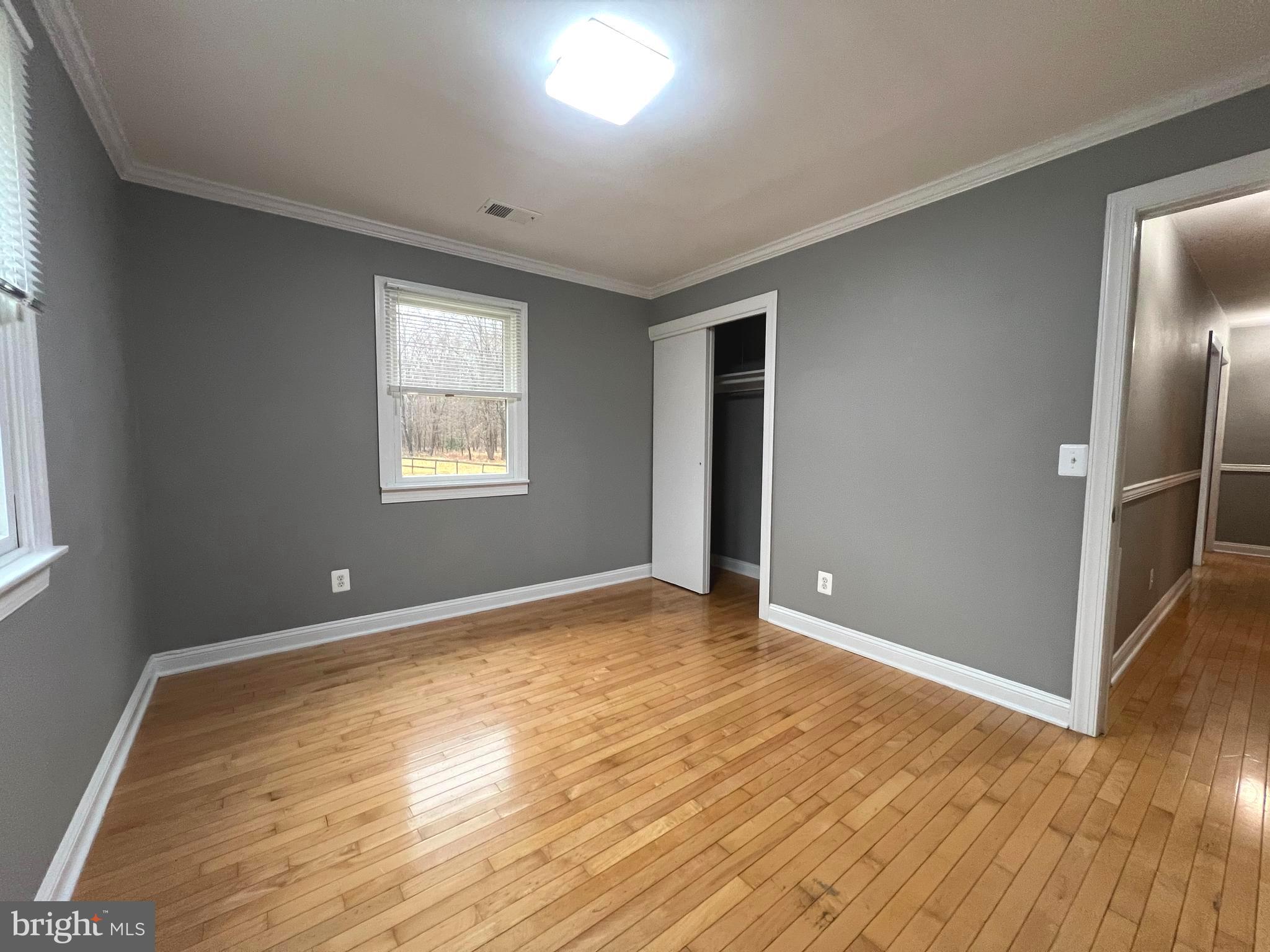 19956 Broad Run Drive Sterling, VA 20165 - Photo 19 of 24 an empty room with wooden floor and windows