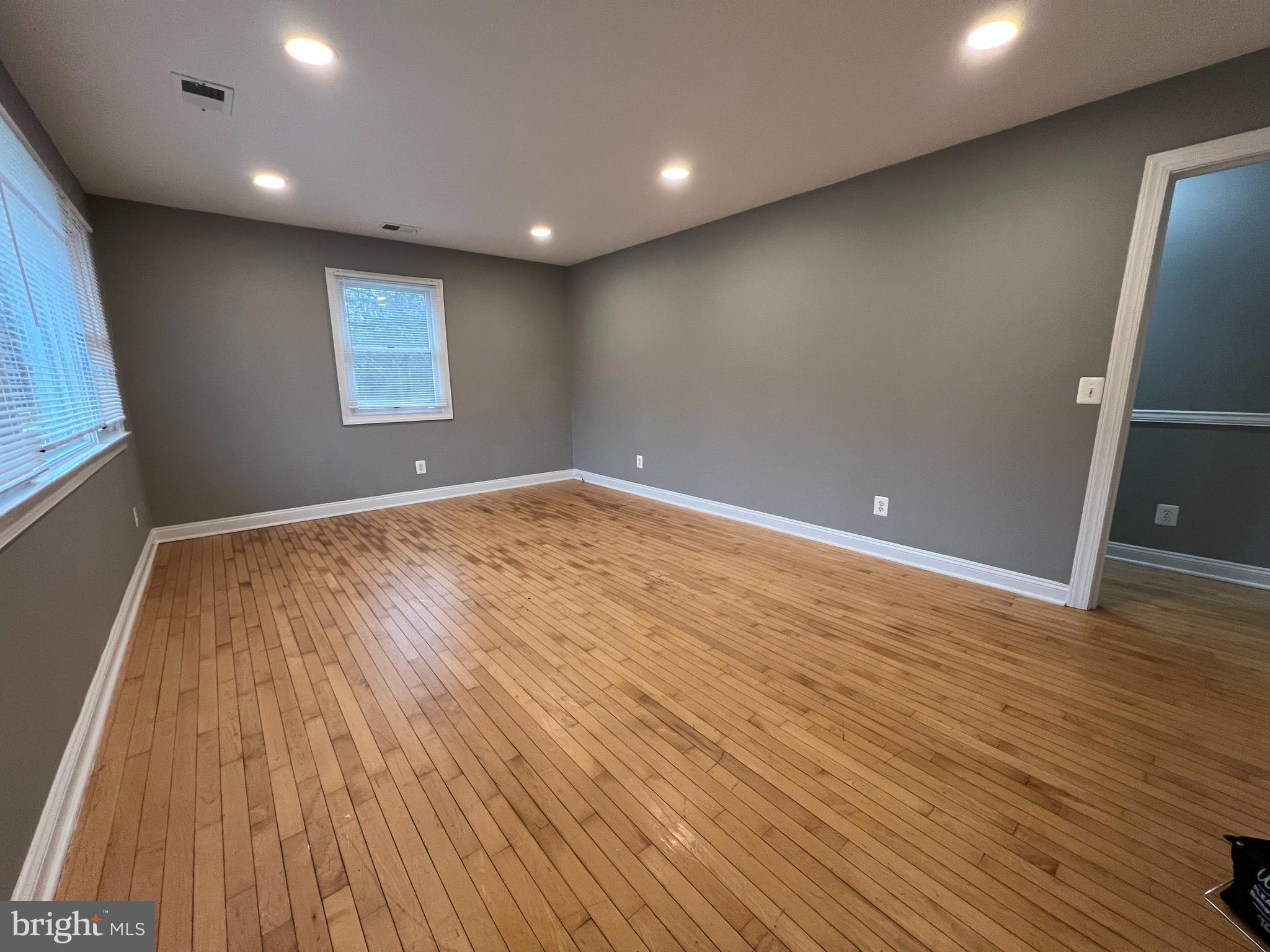 19956 Broad Run Drive Sterling, VA 20165 - Photo 2 of 24 an empty room with wooden floor and windows