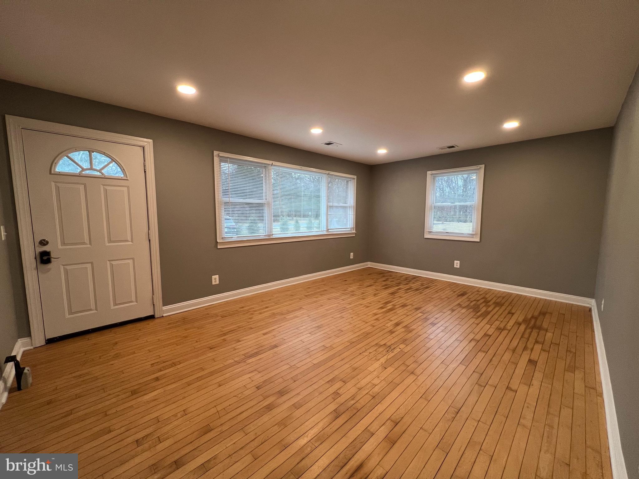 19956 Broad Run Drive Sterling, VA 20165 - Photo 3 of 24 an empty room with wooden floor and windows