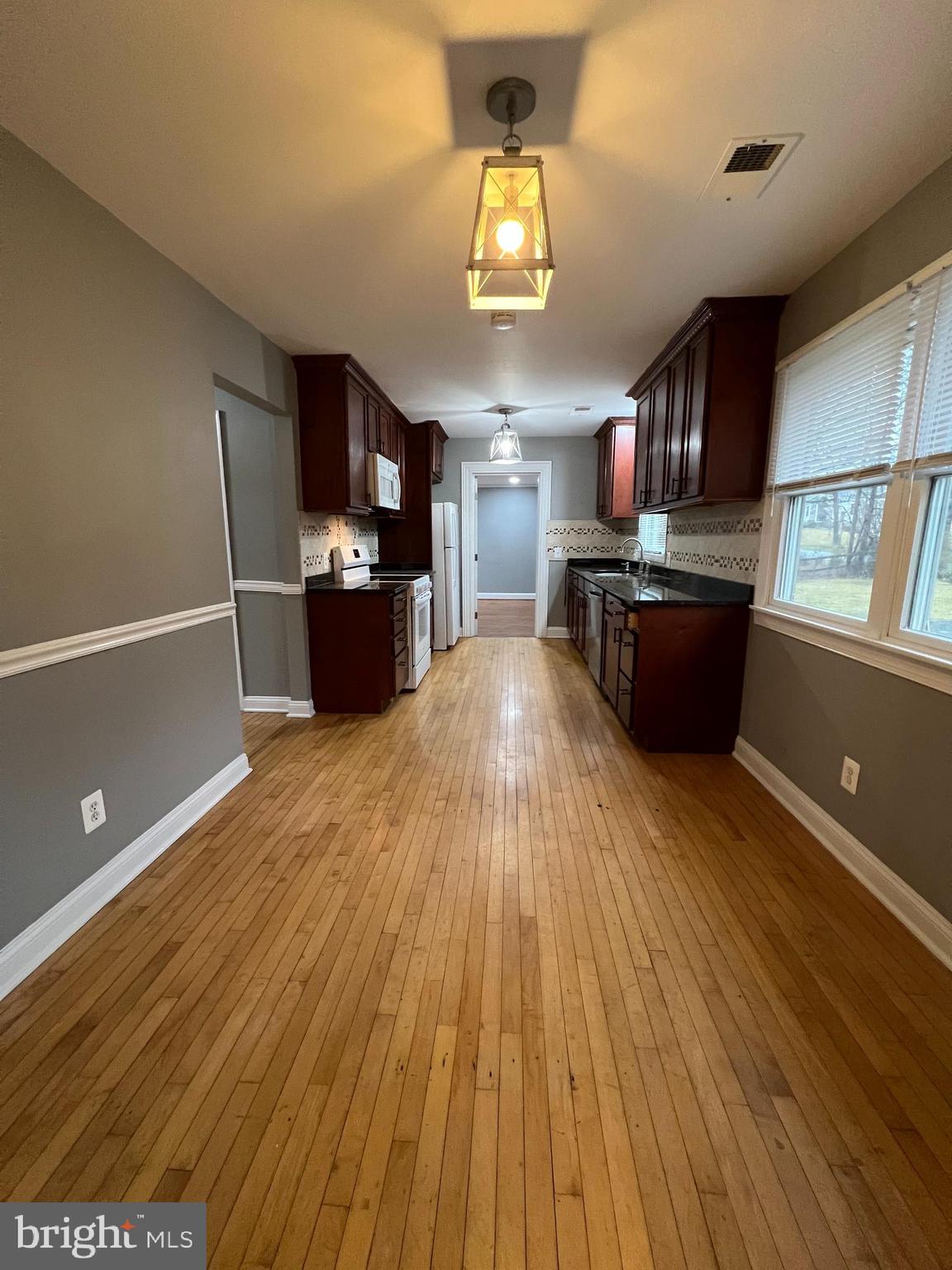19956 Broad Run Drive Sterling, VA 20165 - Photo 4 of 24 a large kitchen with a wooden floor and stainless steel appliances