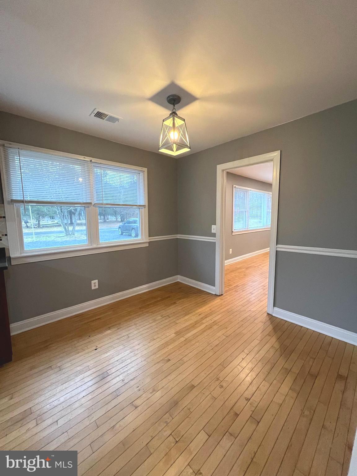 19956 Broad Run Drive Sterling, VA 20165 - Photo 5 of 24 an empty room with wooden floor chandelier and windows