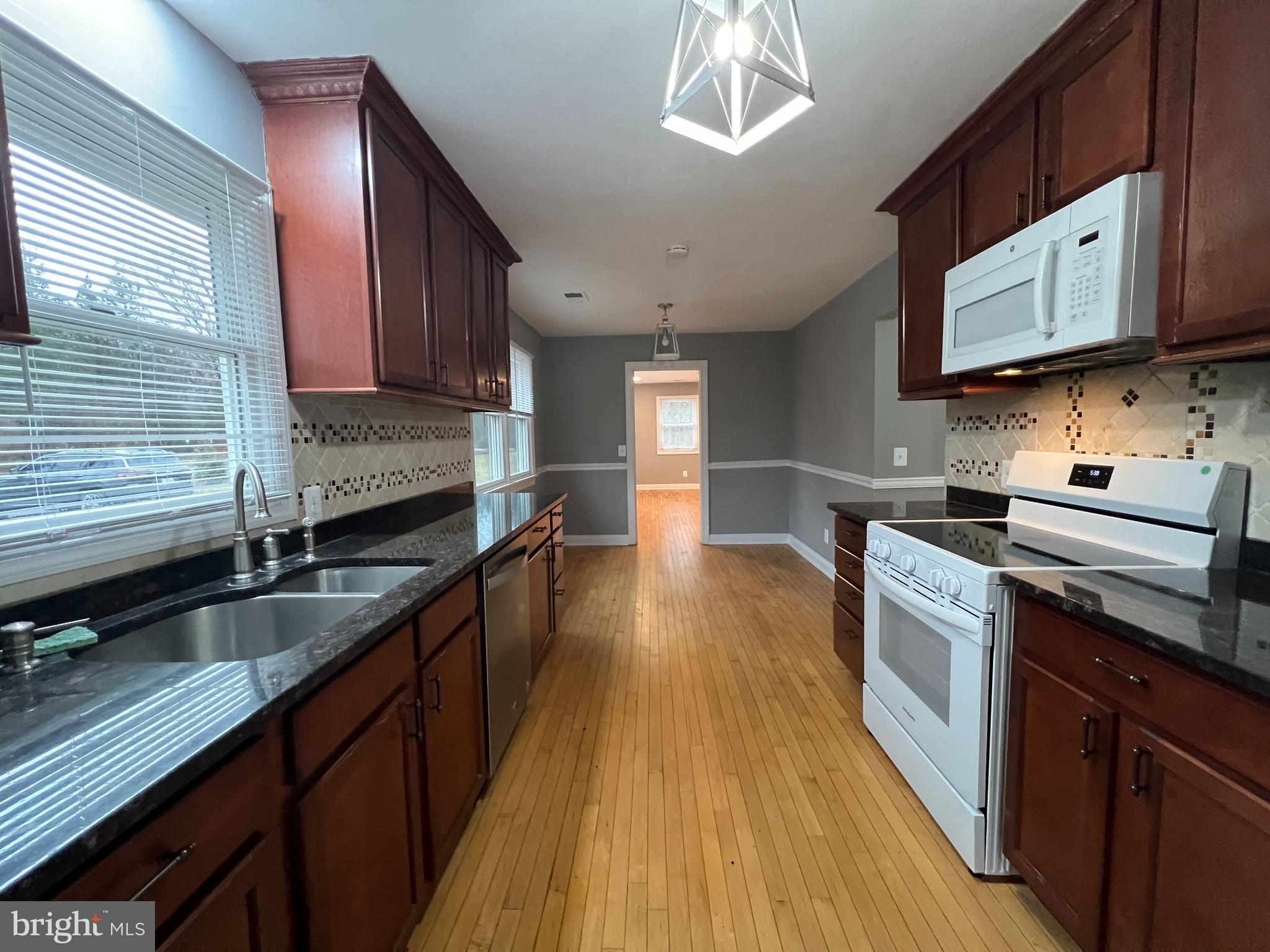 19956 Broad Run Drive Sterling, VA 20165 - Photo 7 of 24 a kitchen with stainless steel appliances granite countertop wooden cabinets a stove a sink and dishwasher