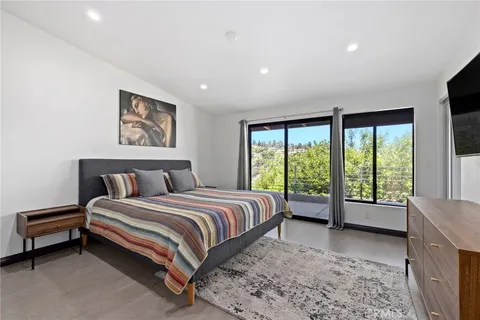 a spacious bedroom with a bed and a large window