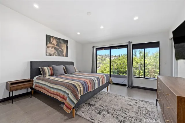 a spacious bedroom with a bed and a large window