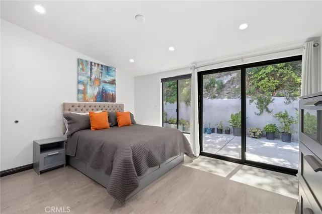 a bedroom with a bed and a large window