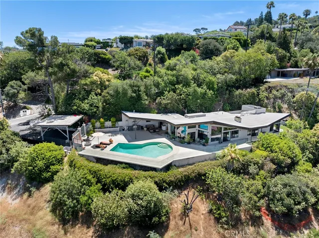 an aerial view of a house with garden space and street view