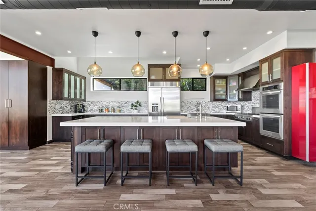 a large kitchen with a table and chairs