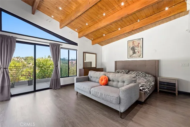 a bedroom with furniture and a large window