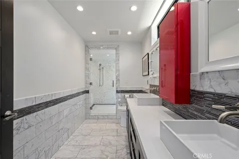 a bathroom with a tub sink and mirror